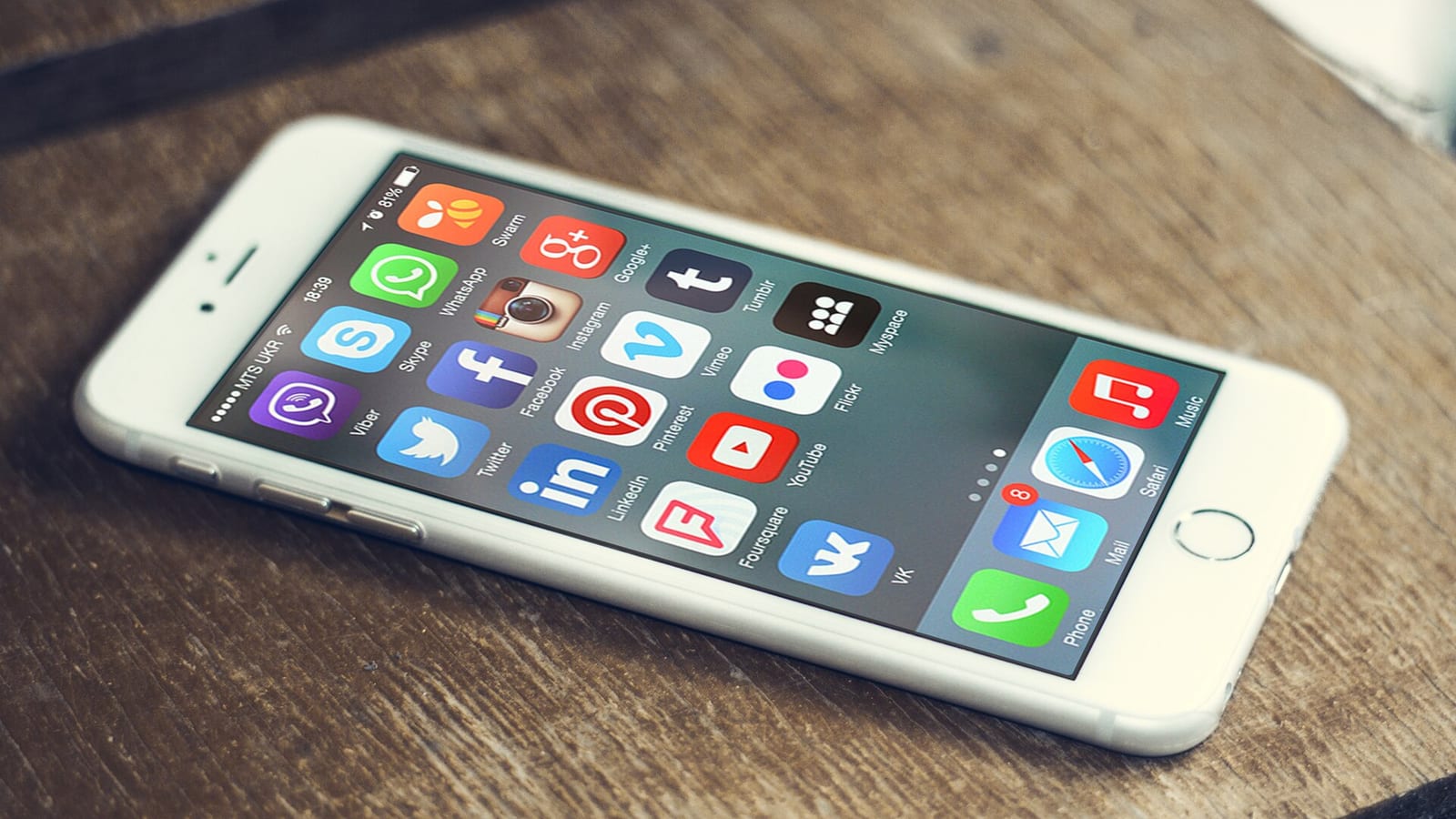 Social-media app icons on a smartphone.