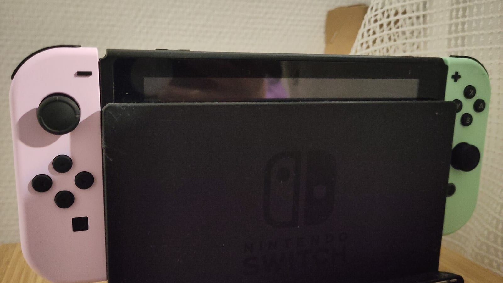 An Animal Crossing edition Nintendo Switch on its dock.